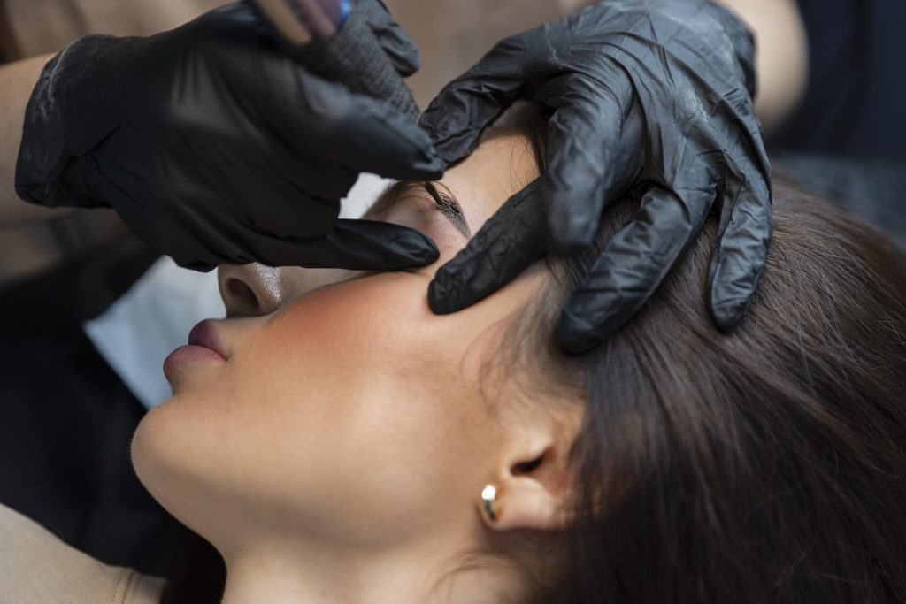 Services young woman getting beauty treatment her eyebrows